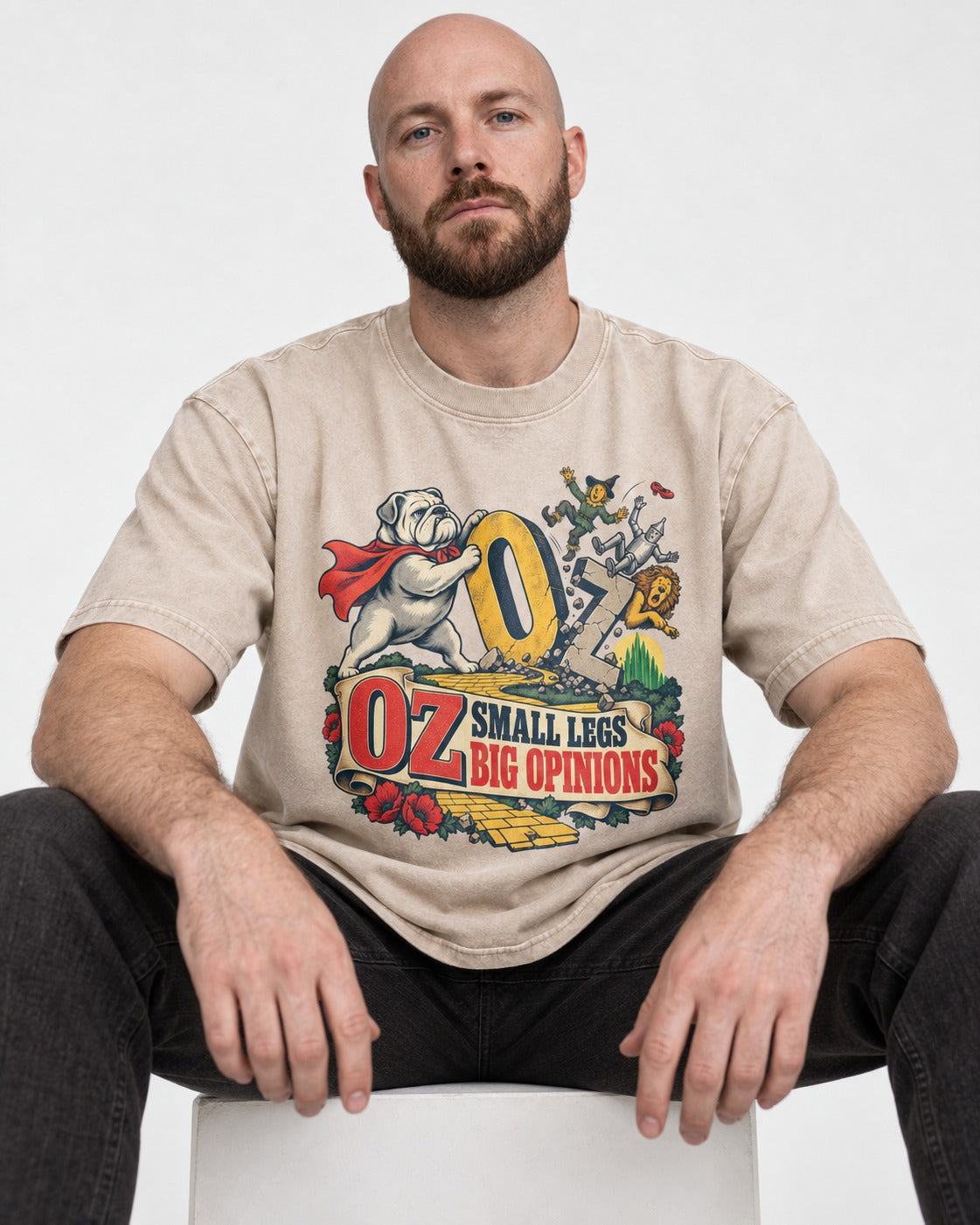 English Bulldog Small Legs Big Opinions Washed Tee in Apricot, worn by a seated model