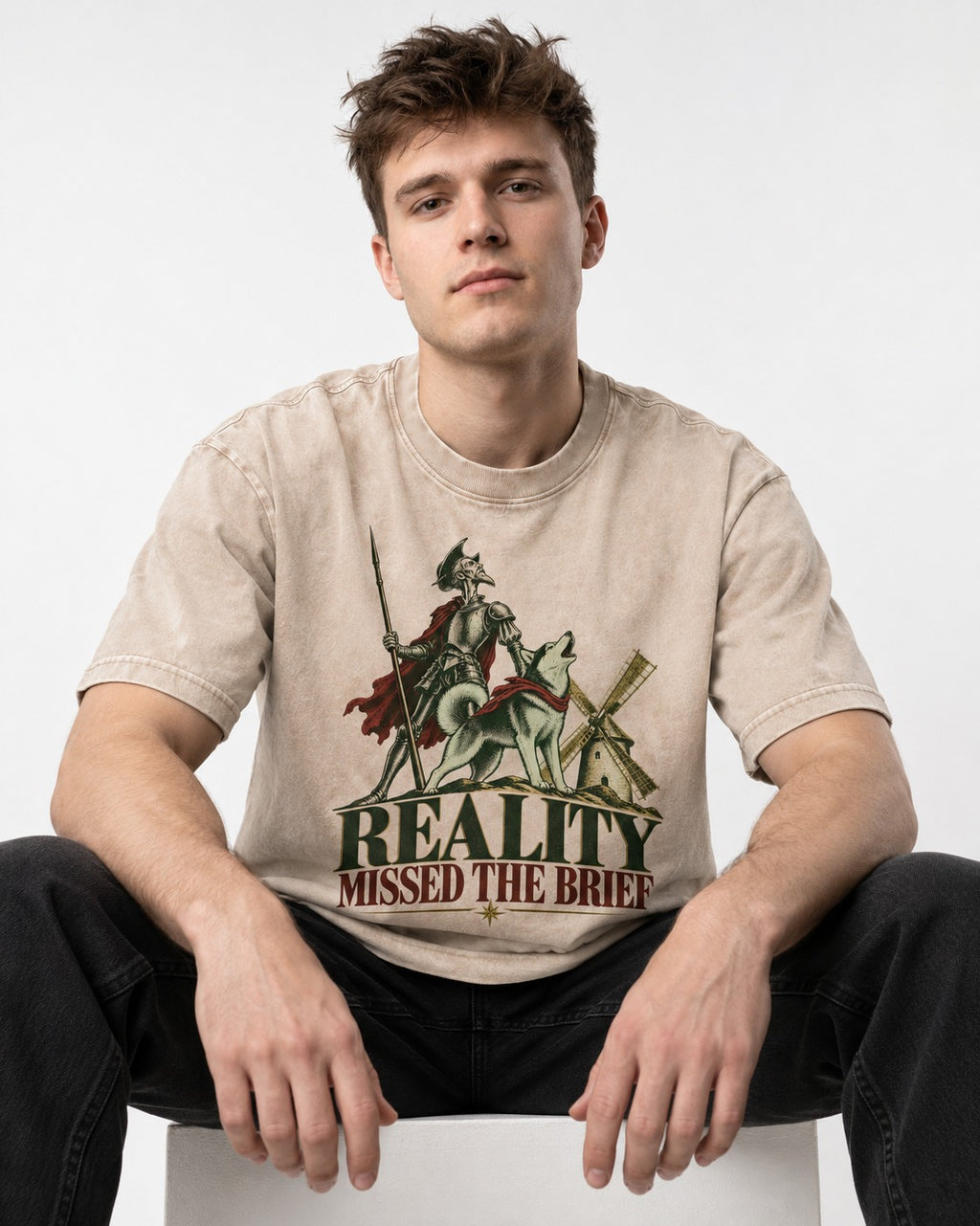 Reality Missed the Husky Brief Washed Tee in Apricot, worn by a seated model