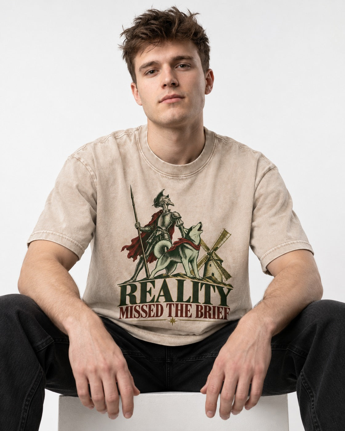 Reality Missed the Husky Brief Washed Tee in Apricot, worn by a seated model