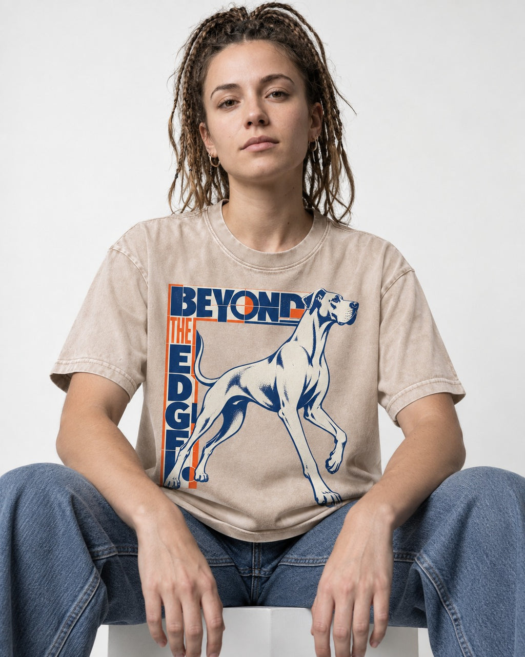 Great Dane Beyond the Edge Washed Tee in Apricot, worn by a seated model