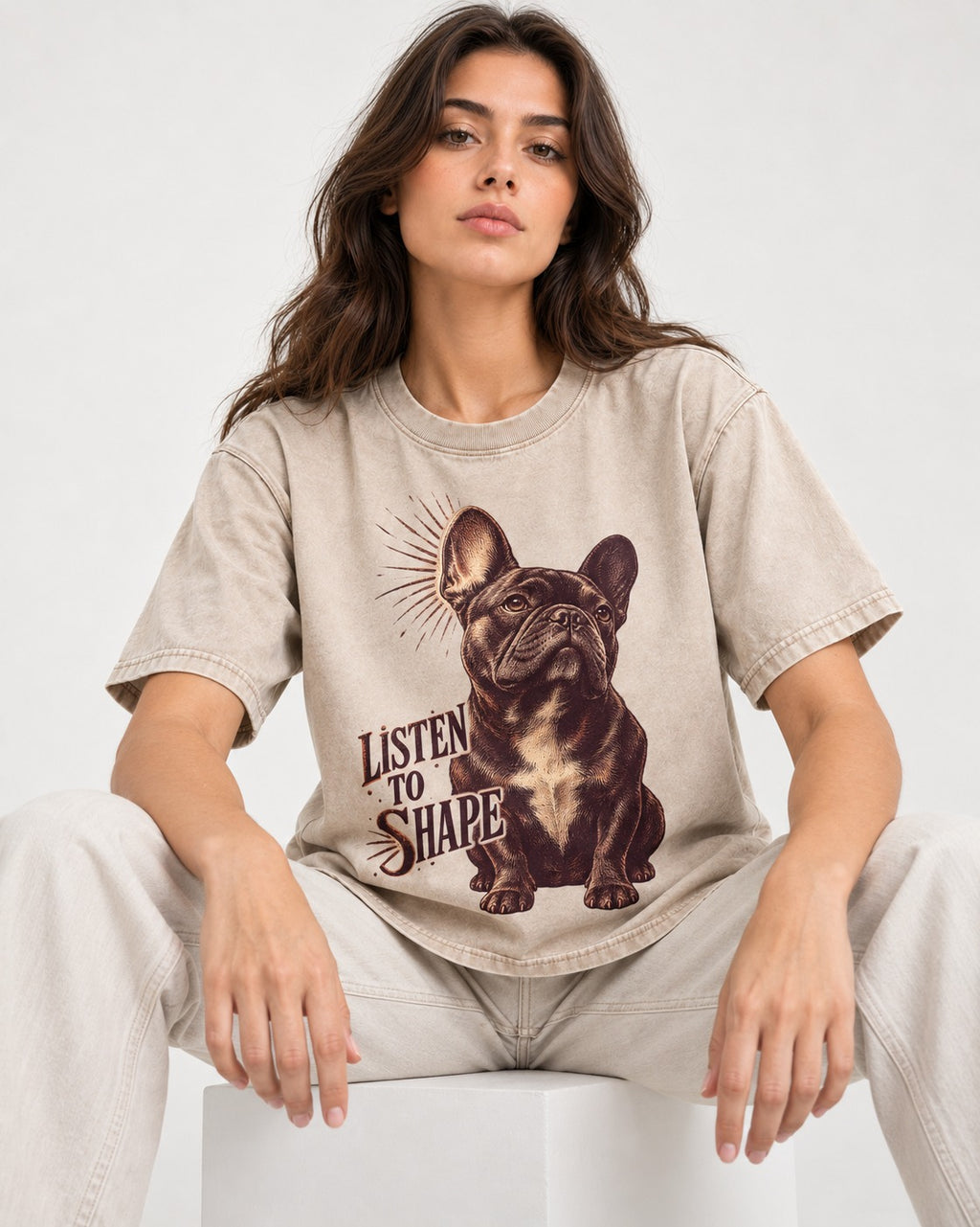 Listen to Shape Frenchie Washed Tee in Apricot, worn by a seated model