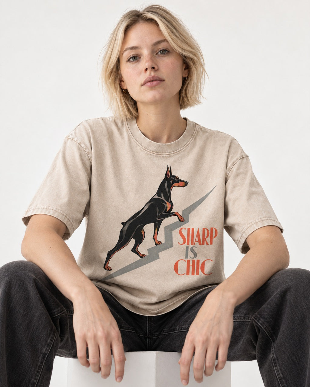 Doberman Is Chic Washed Tee in Apricot, worn by a seated model