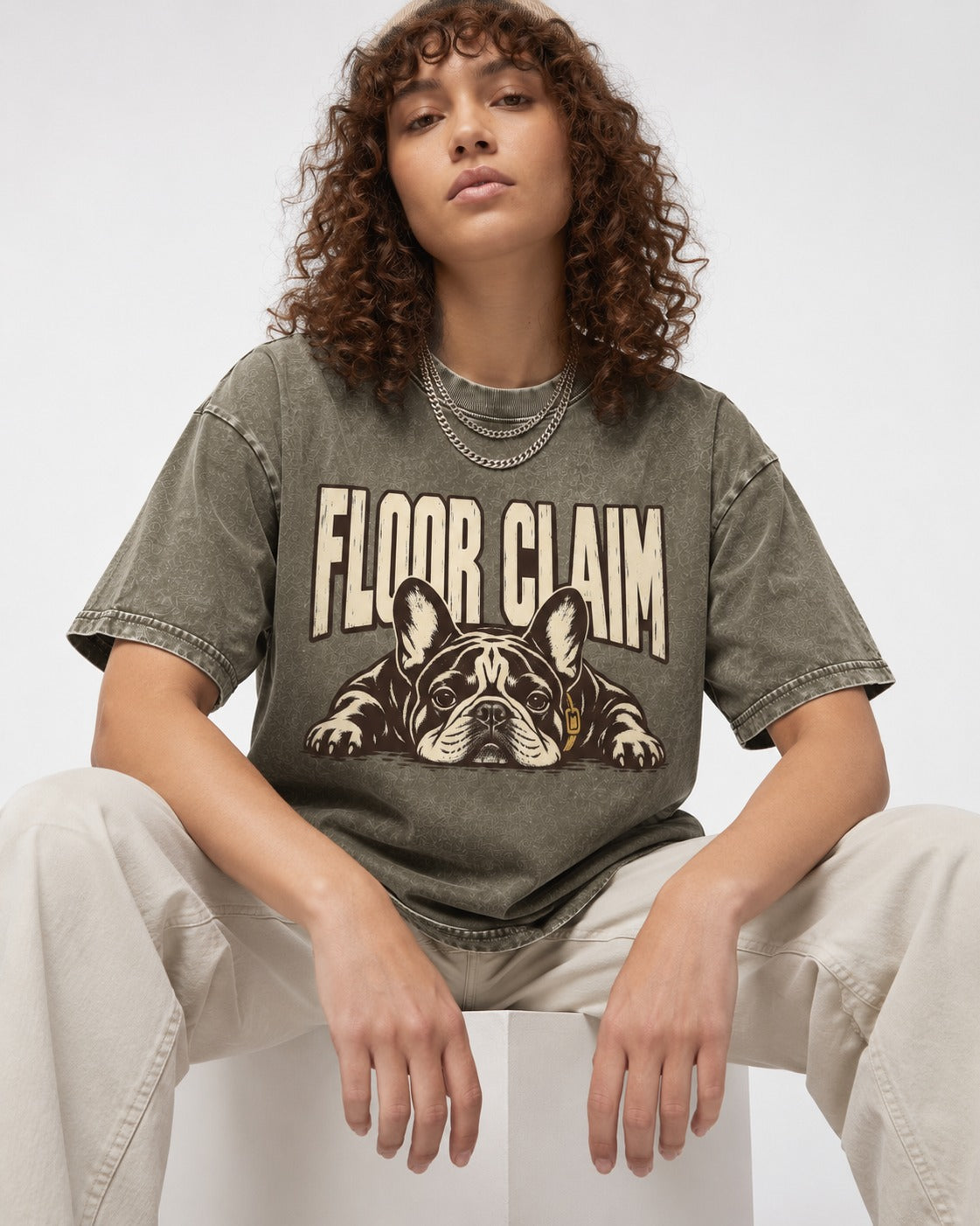 Frenchie Floor Claim Resting Graphic Washed Tee in Army Green, worn by a seated model