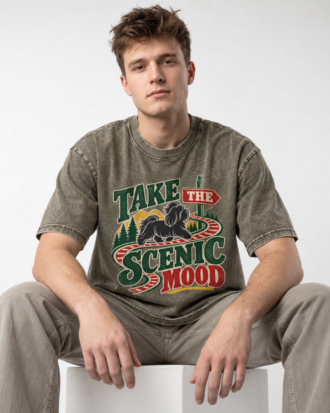 Shih Tzu Take the Scenic Mood Road Sign Graphic Washed Tee in Army Green, worn by a seated model