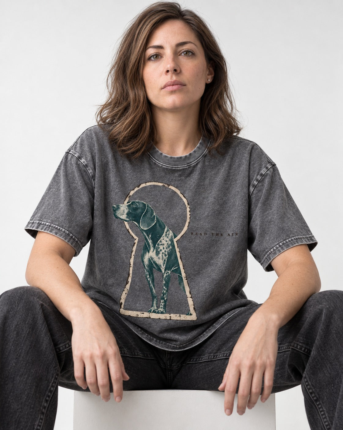Read the Air German Shorthaired Pointer Washed Tee in Gray, worn by a seated model