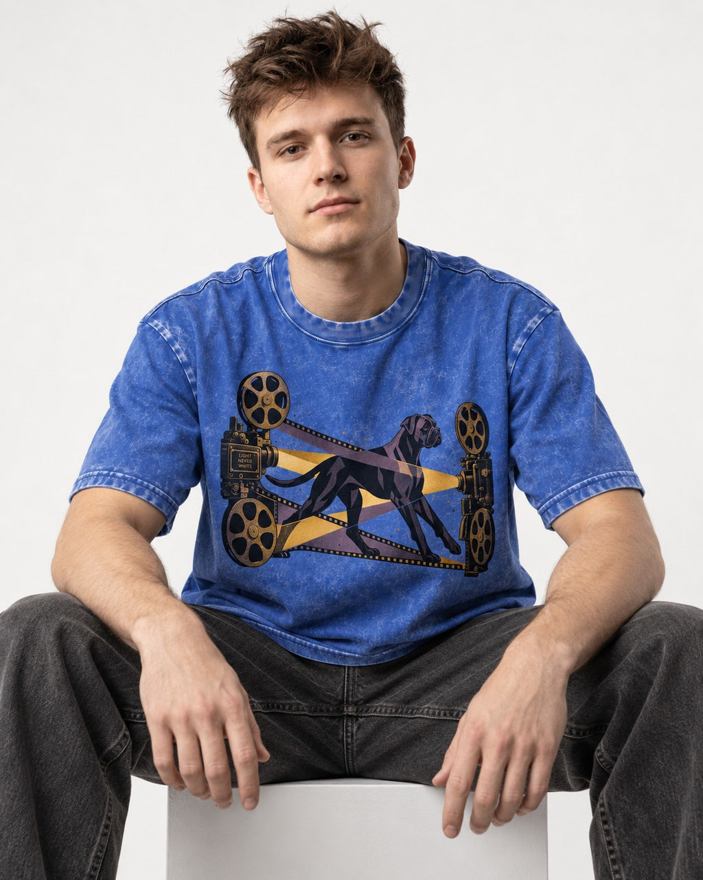 Light Never Waits Boxer Cinema Graphic Washed Tee in Royal Blue, worn by a seated model