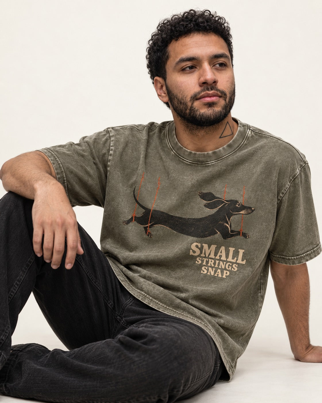 Dachshund Small Strings Snap Marionette Graphic Washed Tee in Army Green, worn by a seated model