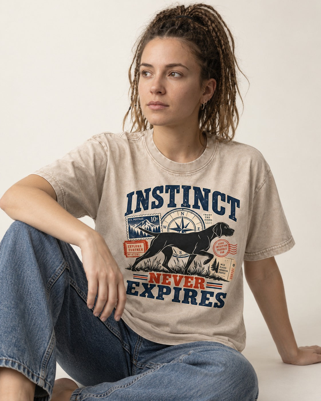 German Shorthaired Pointer Instinct Never Expires Washed Tee in Apricot, worn by a seated model