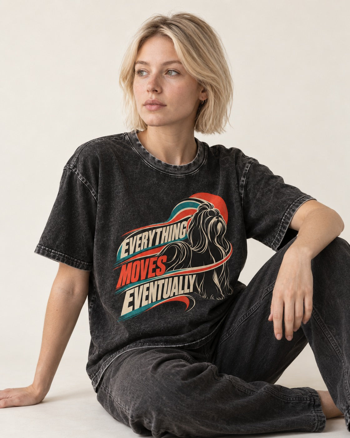 Shih Tzu Everything Moves Eventually Retro Speed Graphic Washed Tee in Black, worn by a seated model