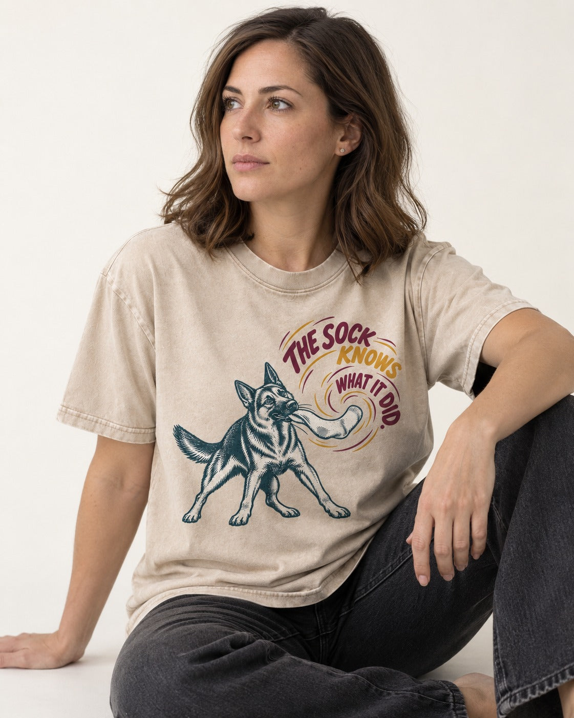 German Shepherd Dog The Sock Knows What I Did Graphic Washed Tee in Apricot, worn by a seated model