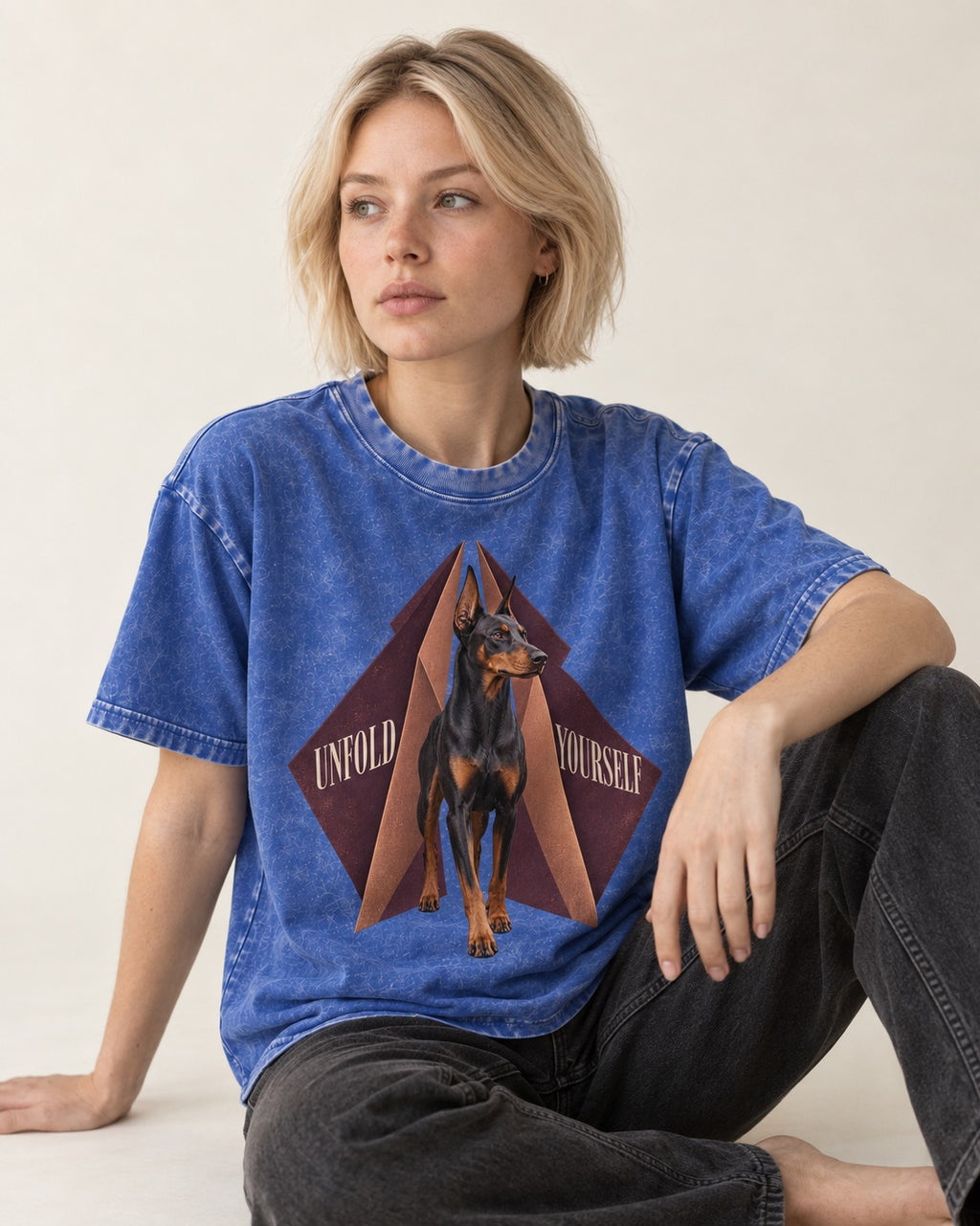 Doberman Unfold Yourself Geometric Portrait Graphic Washed Tee in Royal Blue, worn by a seated model