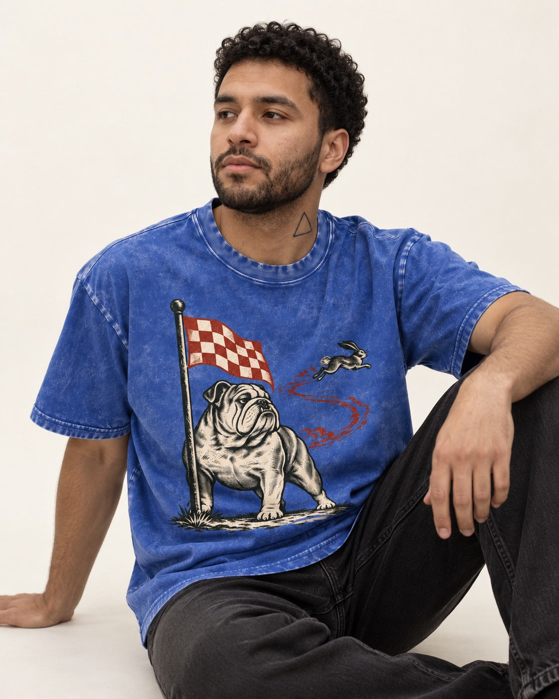 English Bulldog Checkered Flag Rabbit Chase Washed Tee in Royal Blue, worn by a seated model