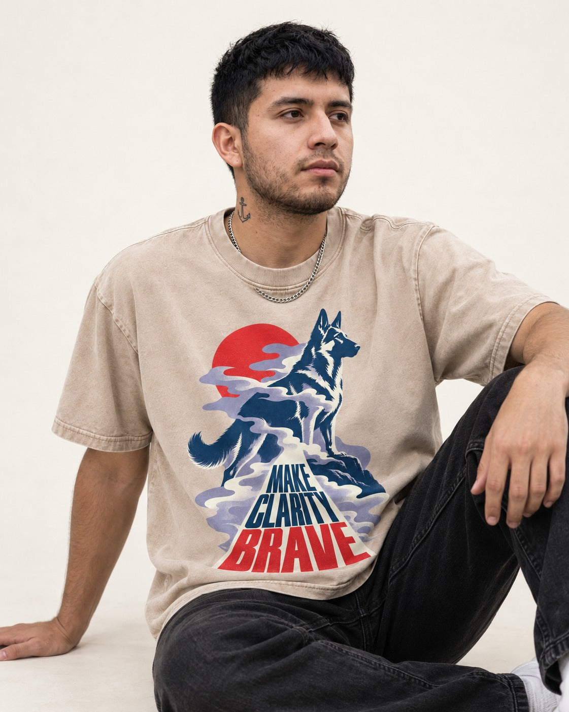 Make Clarity Brave Mountain German Shepherd Dog Graphic Washed Tee in Apricot, worn by a seated model