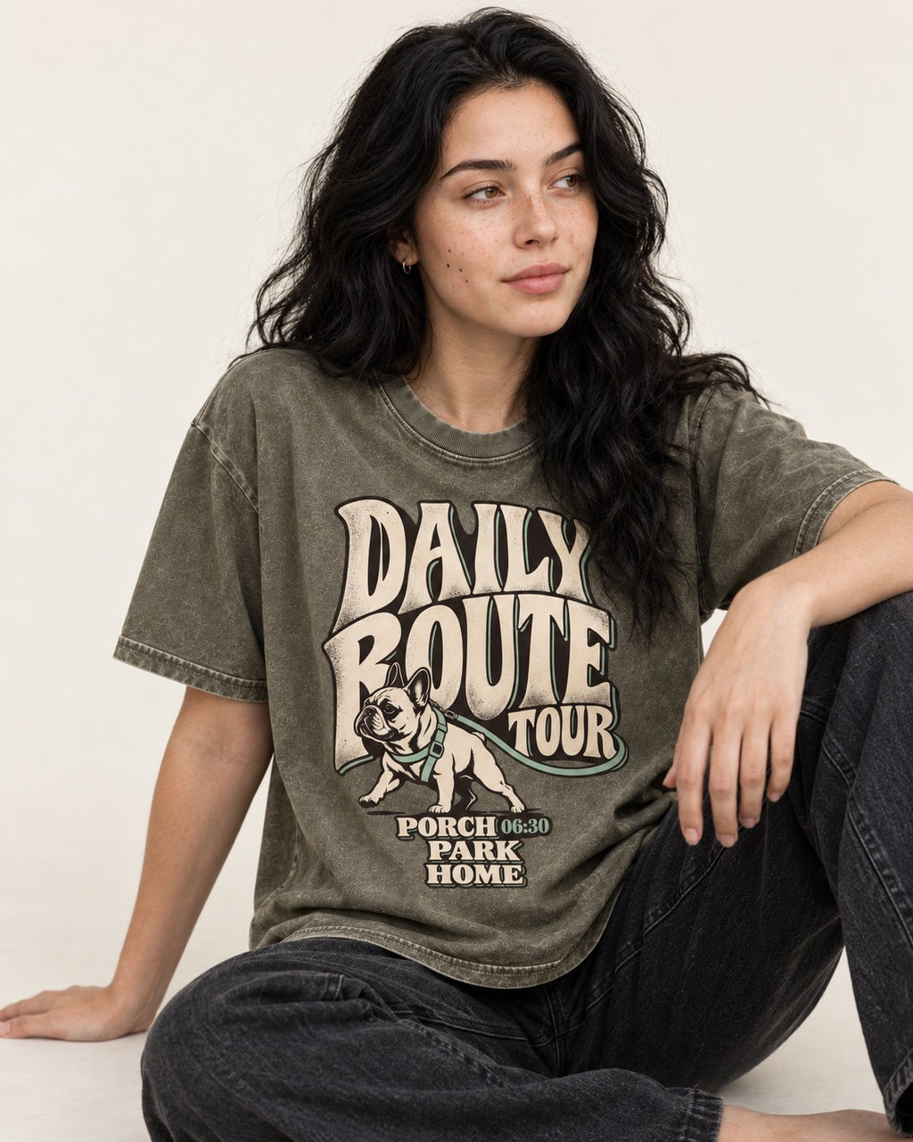Frenchie Daily Route Tour Graphic Washed Tee in Army Green, worn by a seated model
