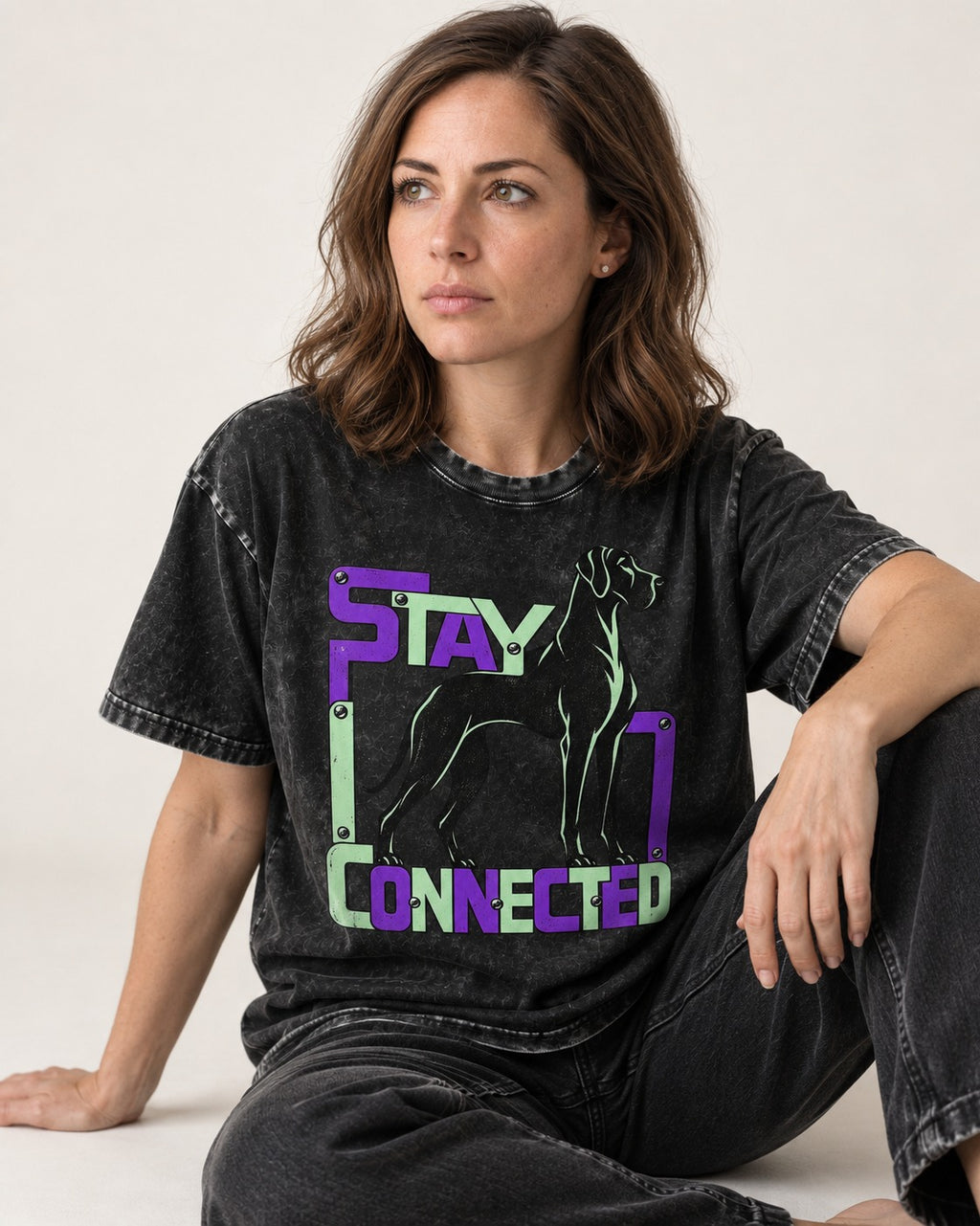 Great Dane Stay Connected Modular Frame Graphic Washed Tee in Black, worn by a seated model