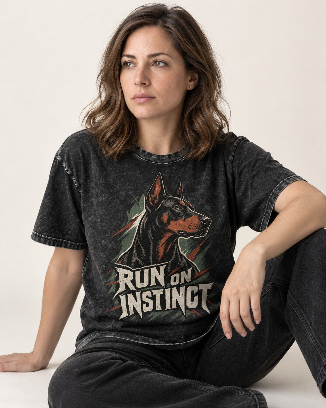 Doberman Run on Instinct Brush Slash Graphic Washed Tee in Black, worn by a seated model