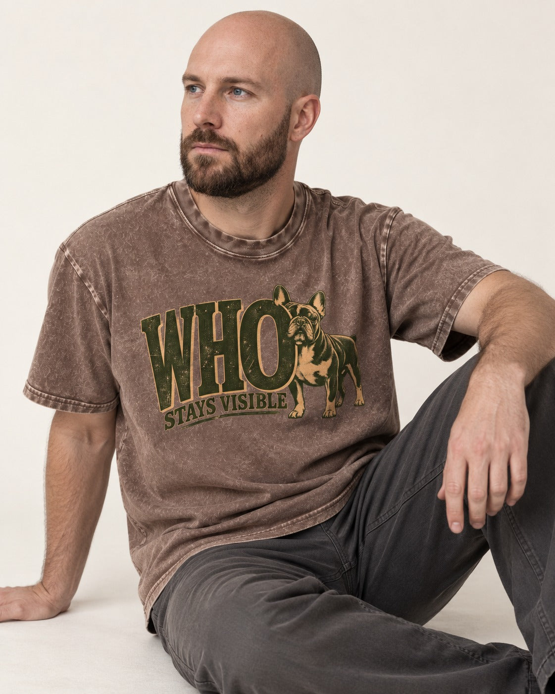 Frenchie Stays Visible Washed Tee in Coffee, worn by a seated model