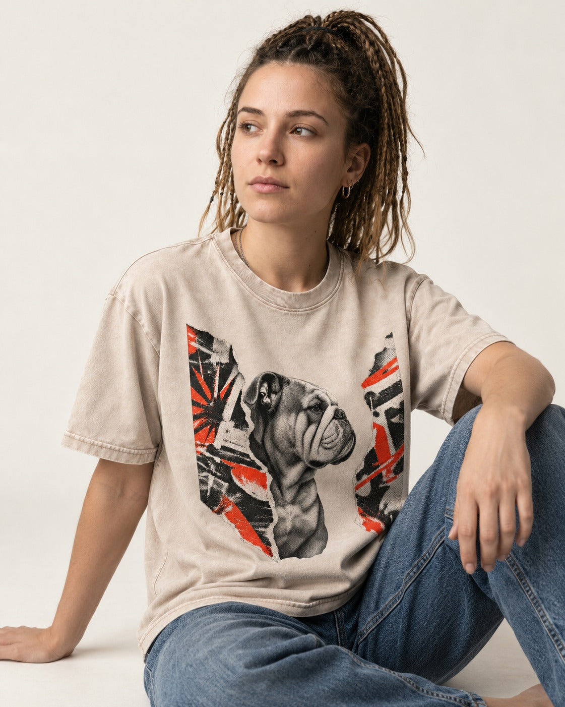 English Bulldog Unbowed Washed Tee in Apricot, worn by a seated model