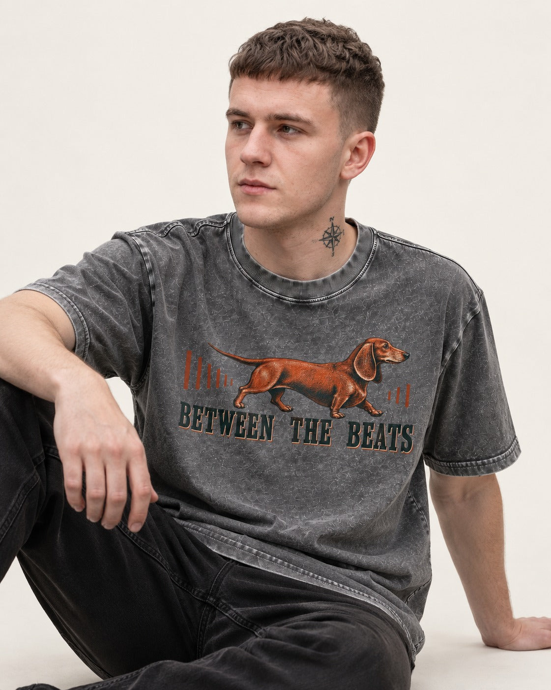 Dachshund Between the Beats Washed Tee in Gray, worn by a seated model