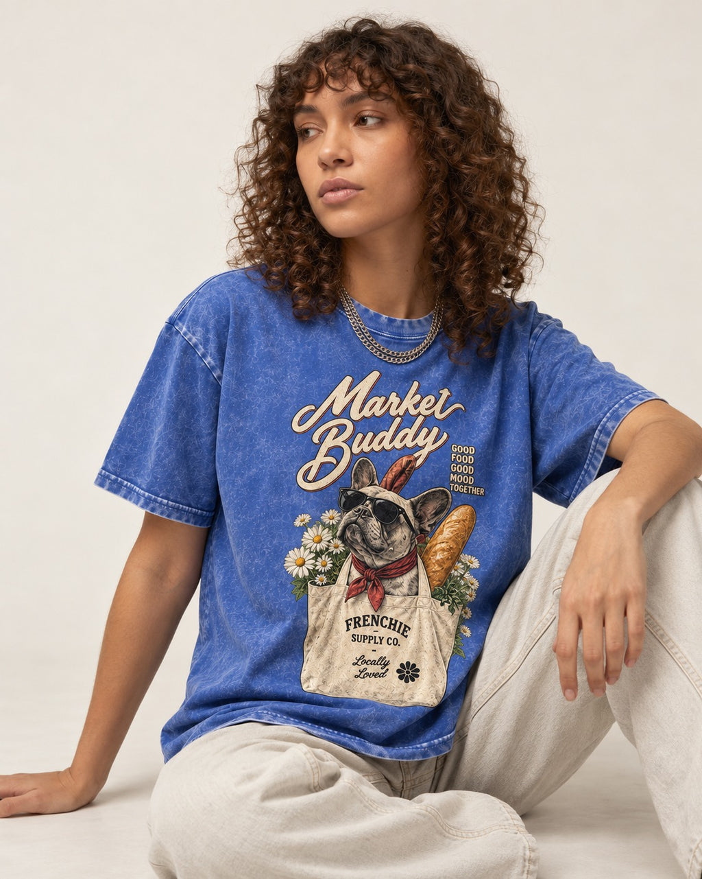 Frenchie Market Buddy Grocery Tote Graphic Washed Tee in Royal Blue, worn by a seated model