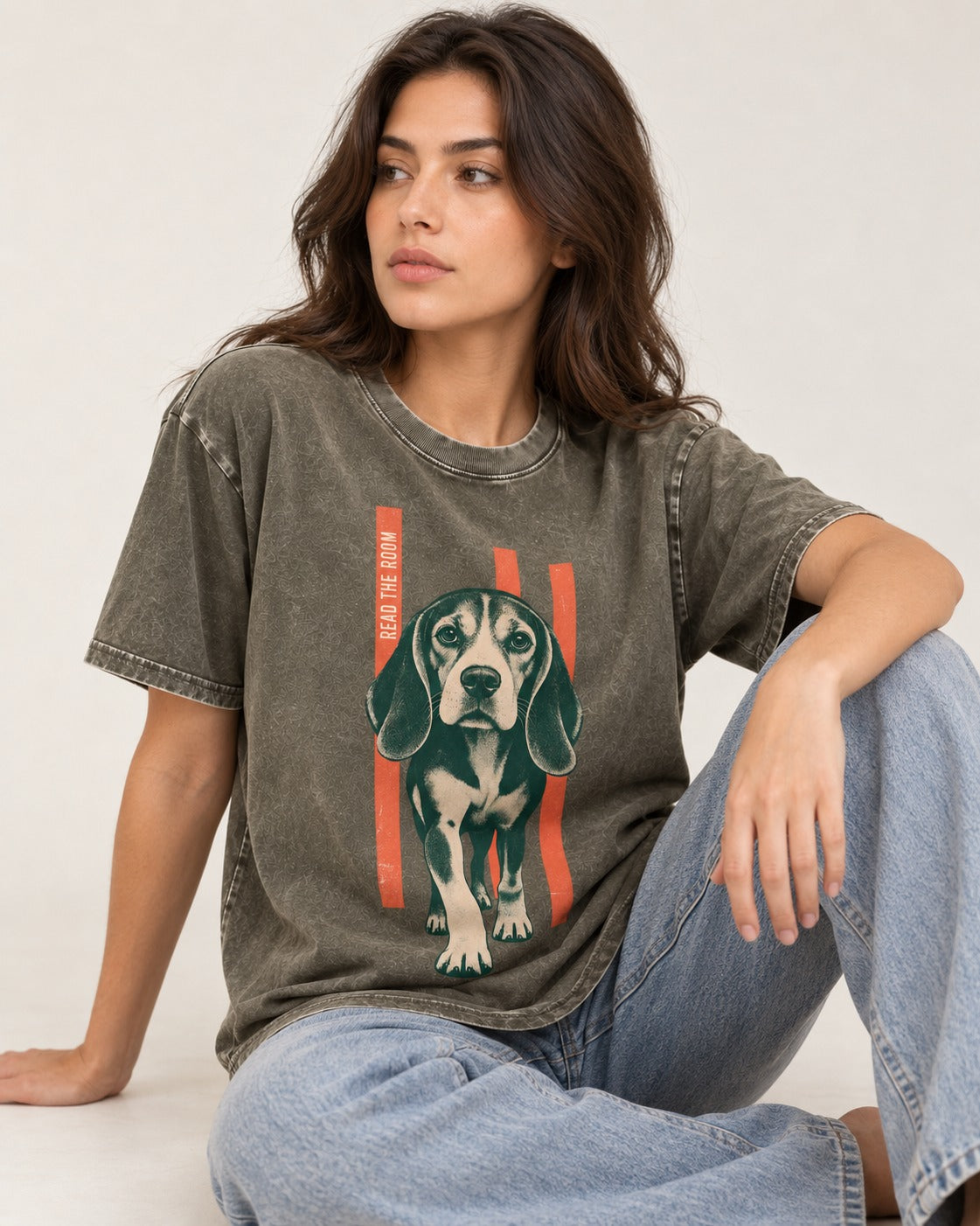 Beagle Before The Move Walking Portrait Washed Tee in Army Green, worn by a seated model