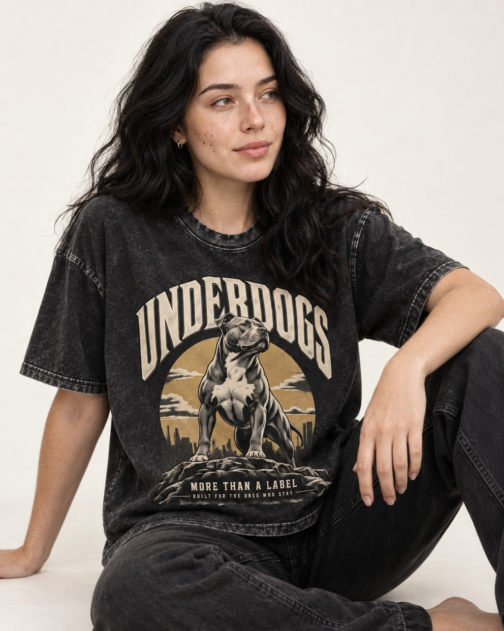 Pitbull Underdogs City Monument Graphic Washed Tee in Black, worn by a seated model