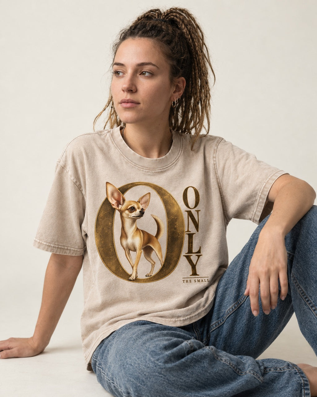 Chihuahua Only the Small Washed Tee in Apricot, worn by a seated model