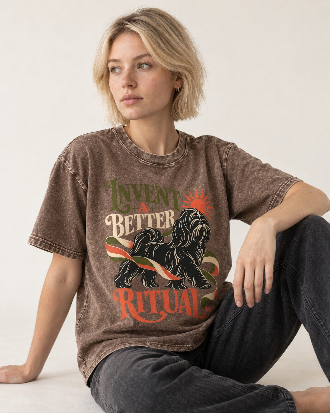 Shih Tzu Invent A Better Ritual Sunrise Ribbon Graphic Washed Tee in Coffee, worn by a seated model