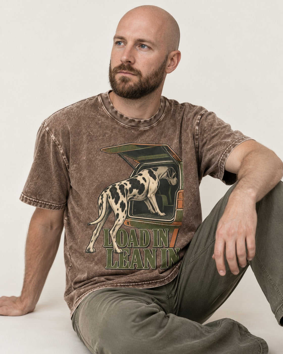 Great Dane Loadin' Leanin' Washed Tee in Coffee, worn by a seated model