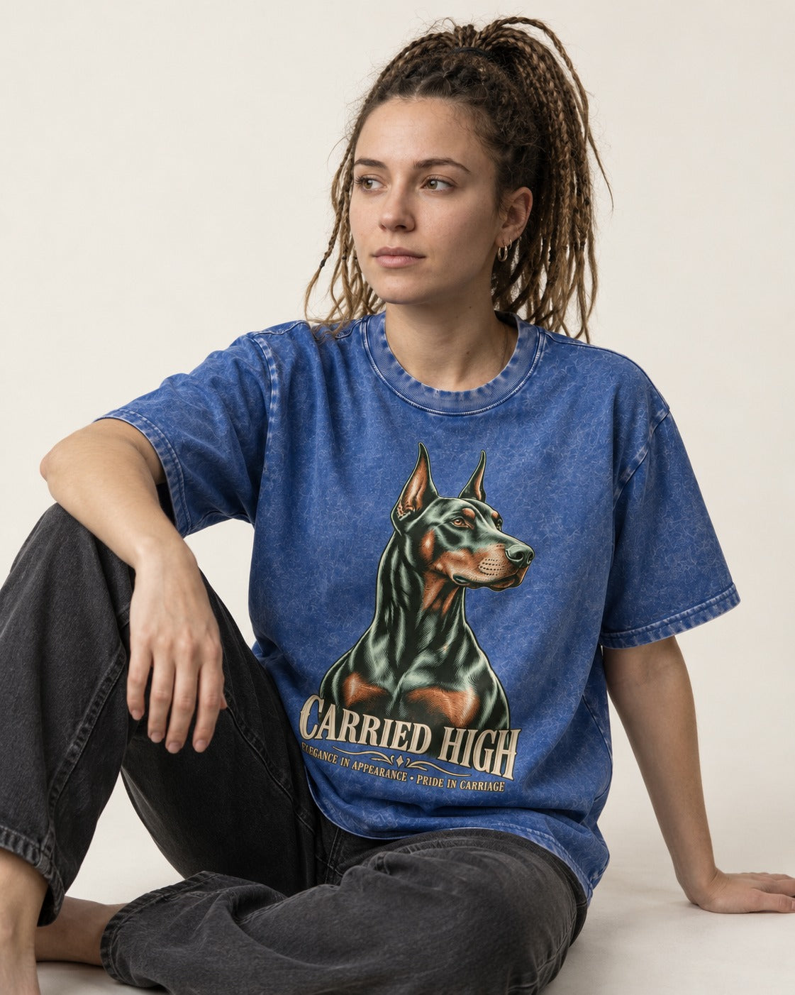 Doberman Carried High Portrait Graphic Washed Tee in Royal Blue, worn by a seated model
