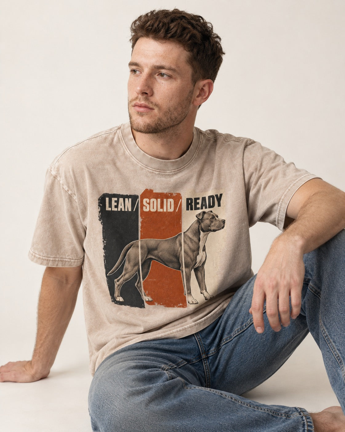 Pitbull Lean Solid Ready Triptych Graphic Washed Tee in Apricot, worn by a seated model