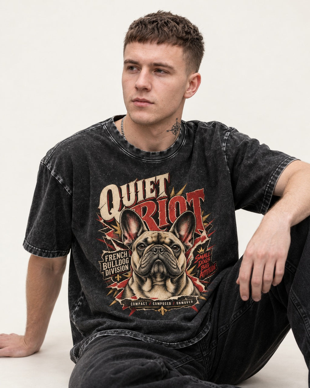 Frenchie Quiet Riot Division Emblem Washed Tee in Black, worn by a seated model