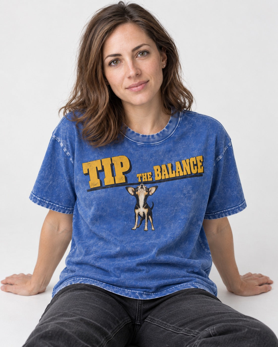 Chihuahua Tip the Balance Beam Graphic Washed Tee in Royal Blue, worn by a seated model