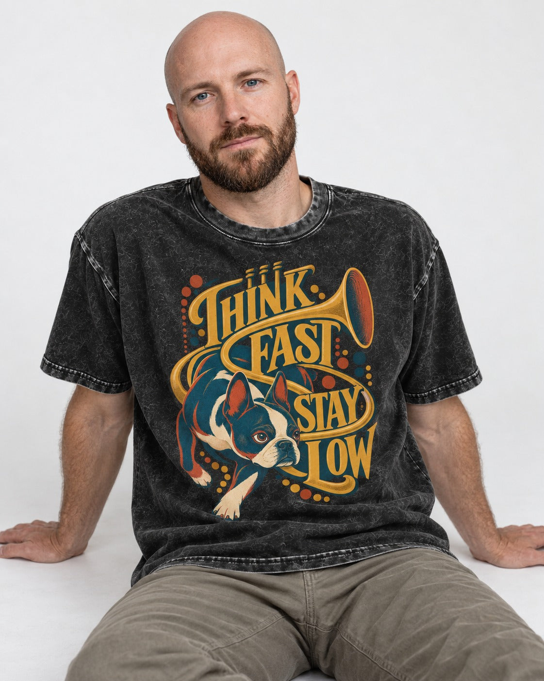 Boston Terrier Think Fast Stay Low Washed Tee in Black, worn by a seated model