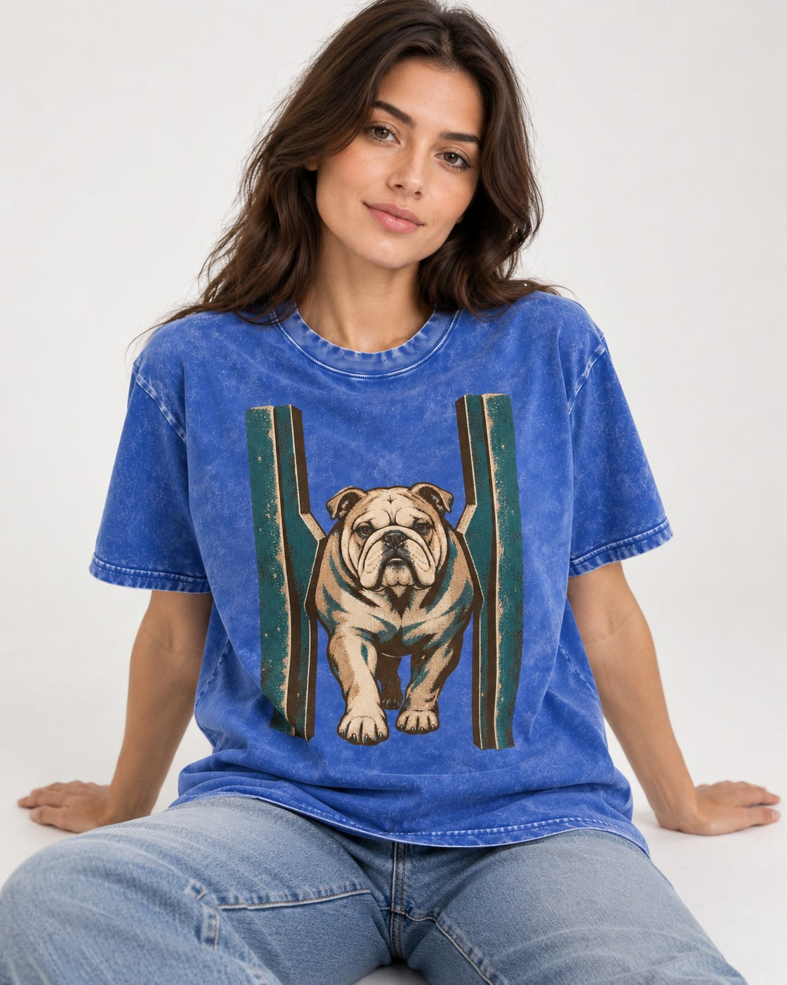 English Bulldog Walking Through Teal Gate Graphic Washed Tee in Royal Blue, worn by a seated model