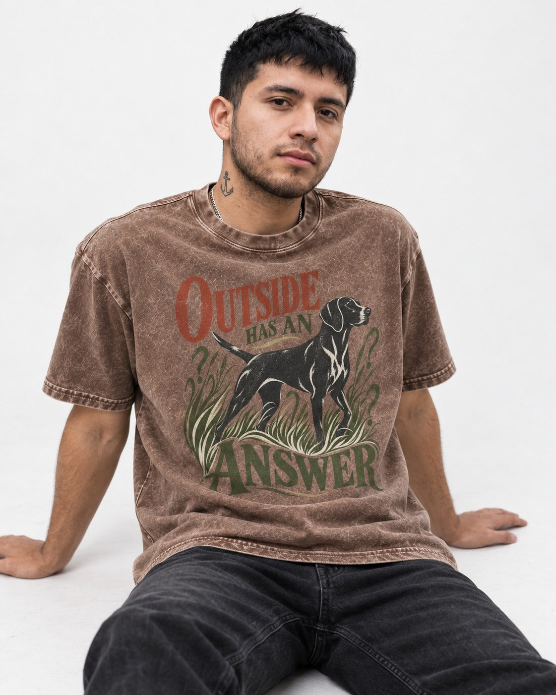 Outside Has an Answer German Shorthaired Pointer Washed Tee in Coffee, worn by a seated model