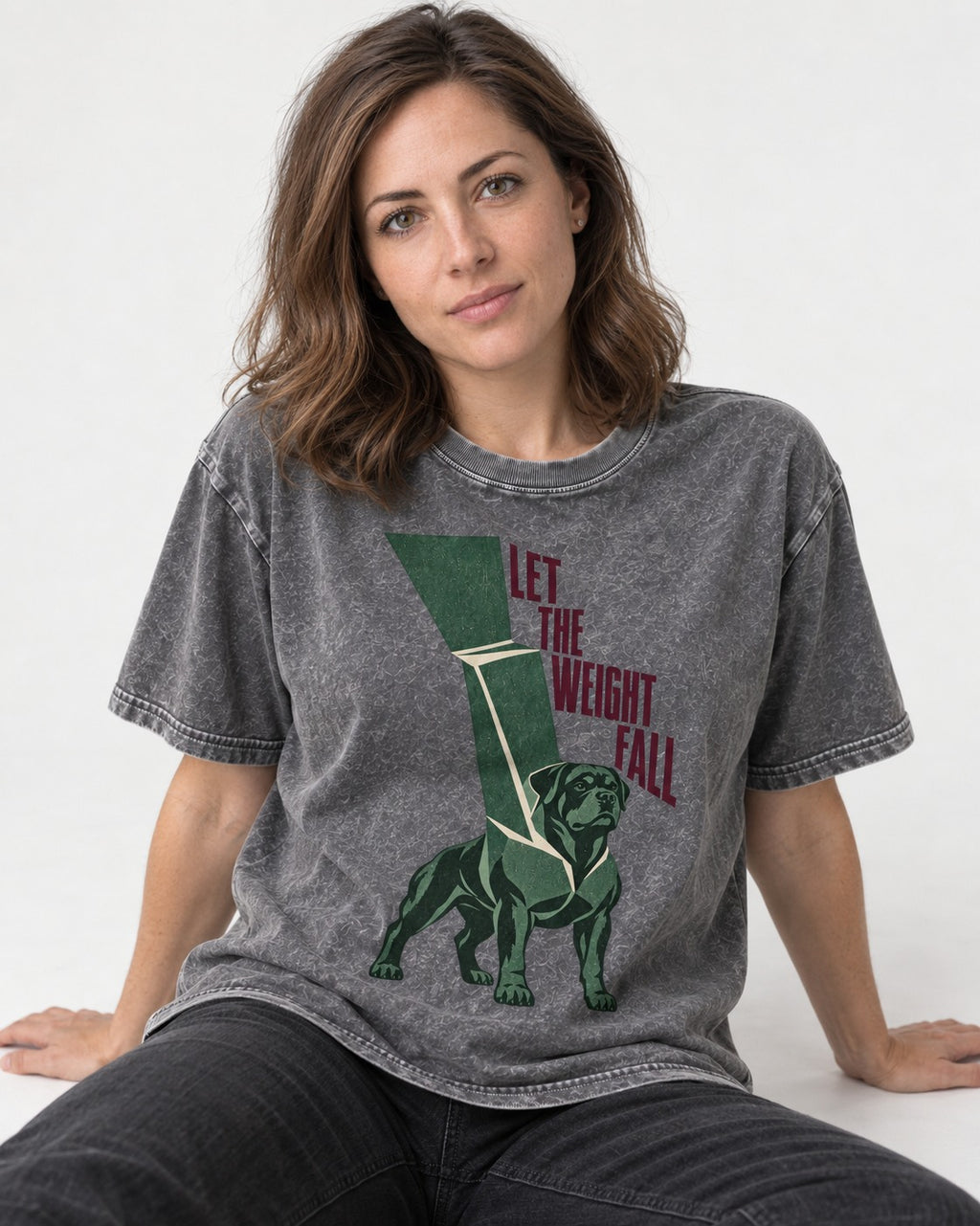 Let the Weight Fall Rottweiler Washed Tee in Gray, worn by a seated model