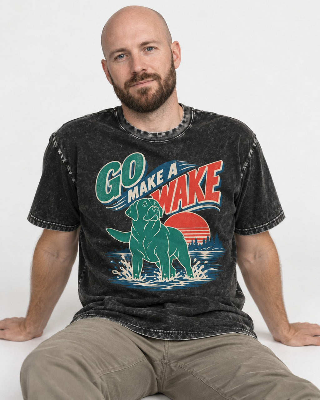 Labrador Retriever Go Make a Wake Lake Graphic Washed Tee in Black, worn by a seated model