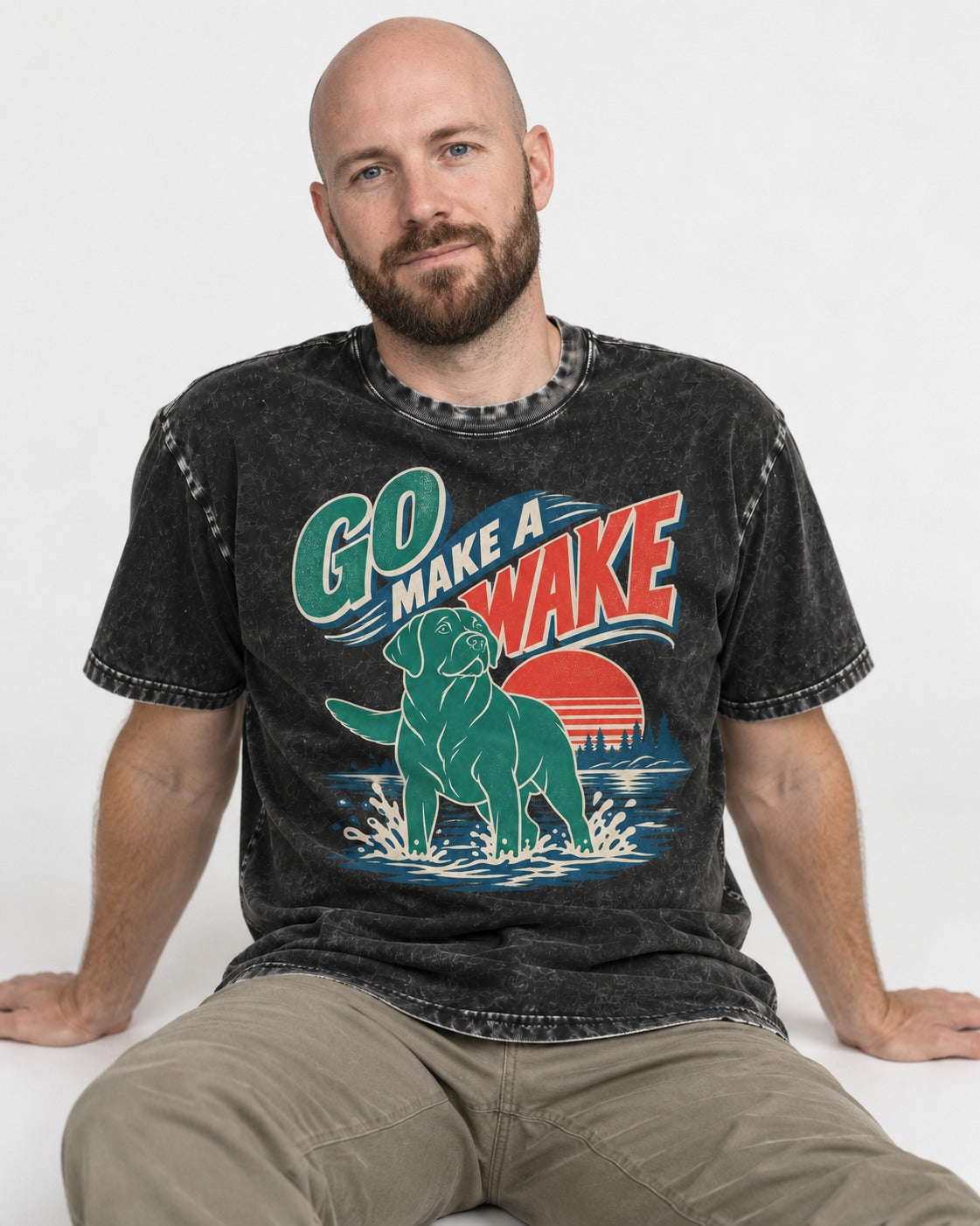 Labrador Retriever Go Make a Wake Lake Graphic Washed Tee in Black, worn by a seated model