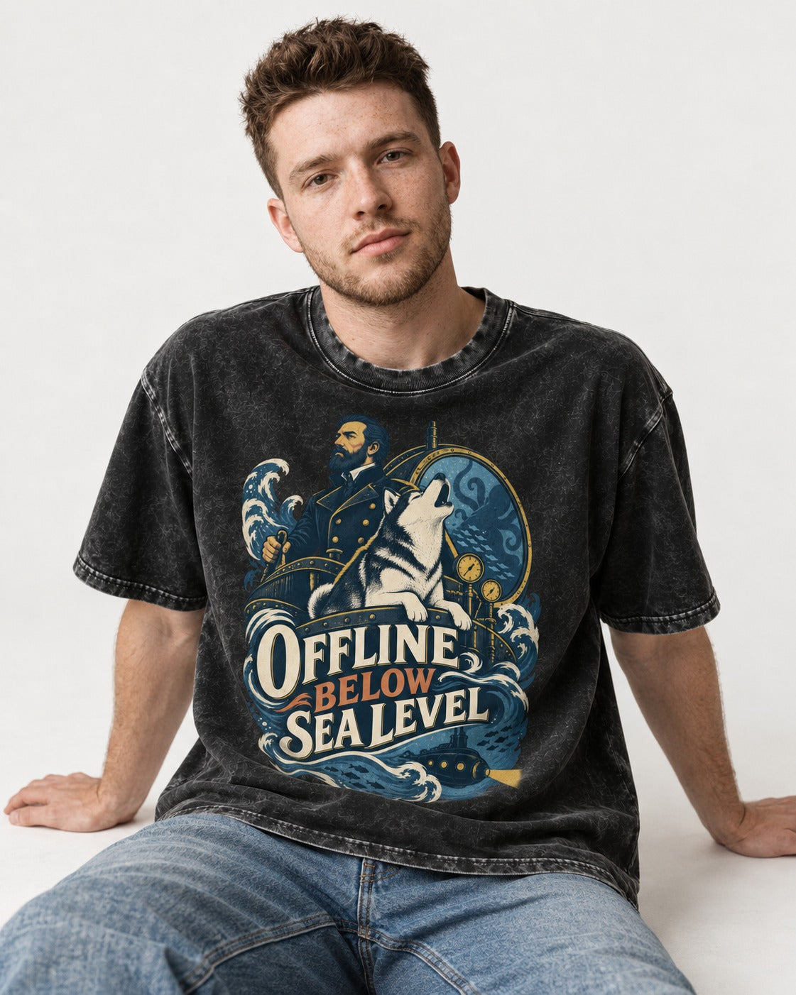Husky Offline Below Sea Level Nautical Submarine Graphic Washed Tee in Black, worn by a seated model