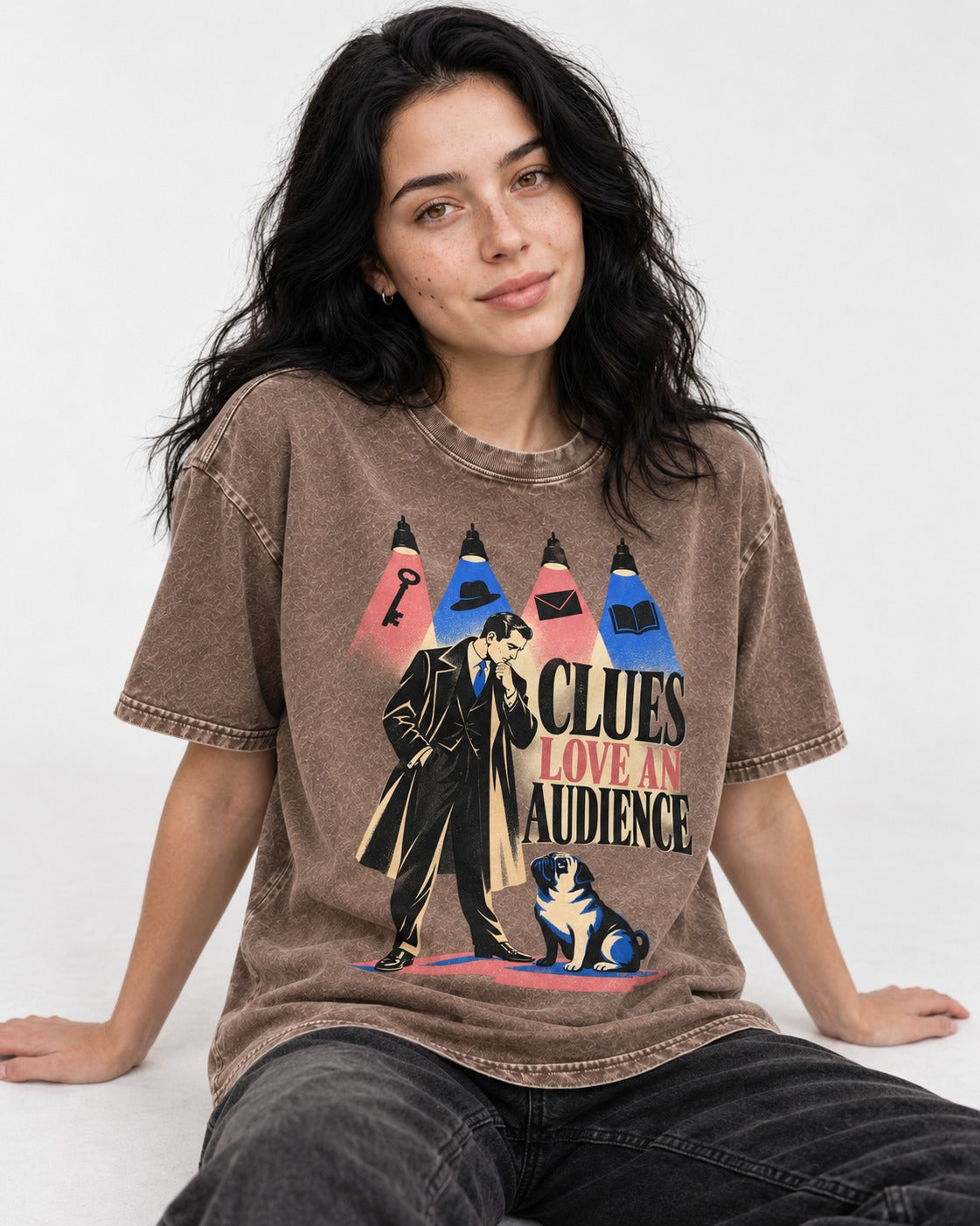 Pug Clues Love an Audience Washed Tee in Coffee, worn by a seated model