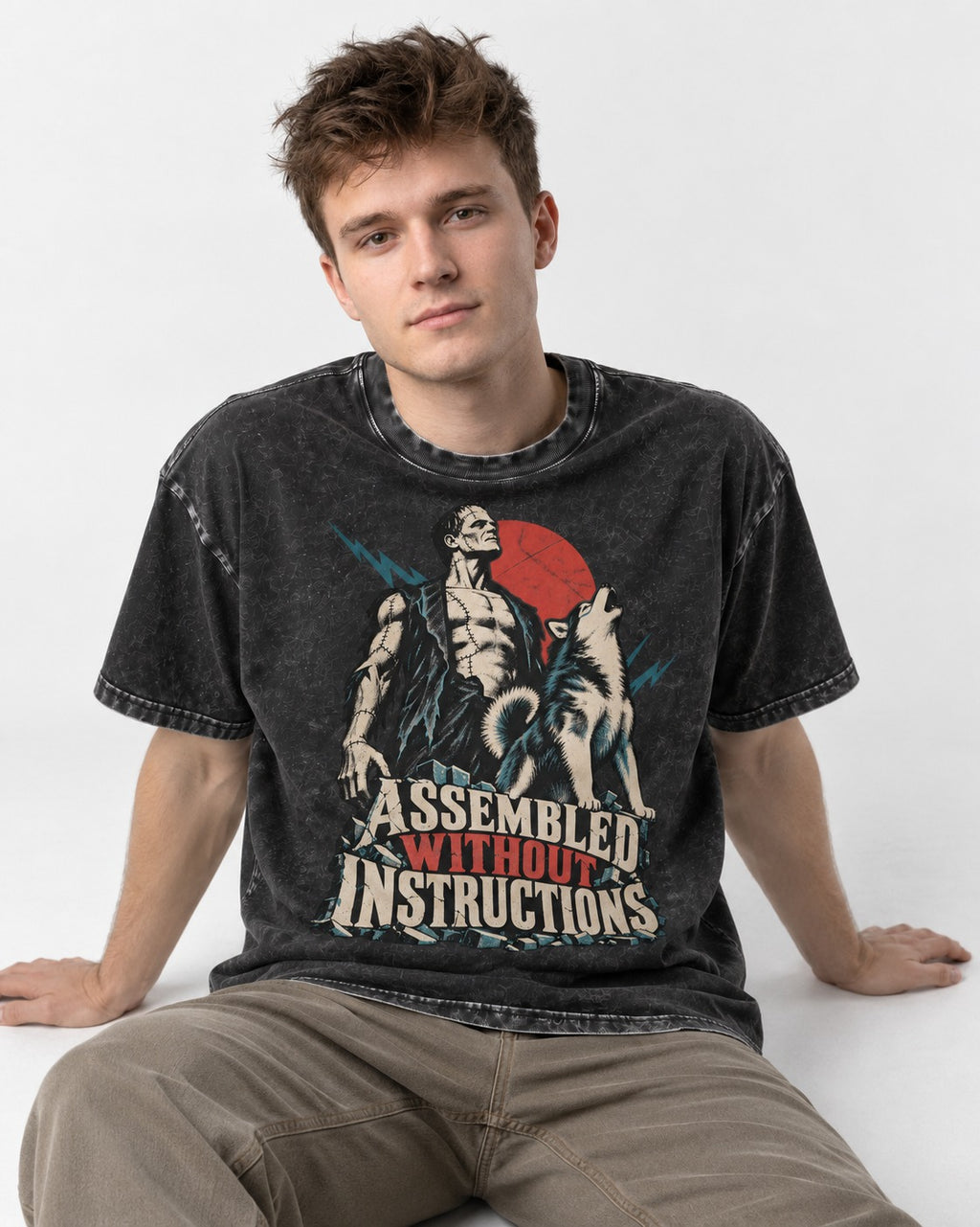 Husky Assembled Without Instructions Frankenstein Graphic Washed Tee in Black, worn by a seated model