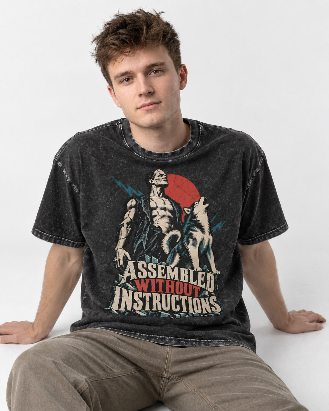 Husky Assembled Without Instructions Frankenstein Graphic Washed Tee in Black, worn by a seated model