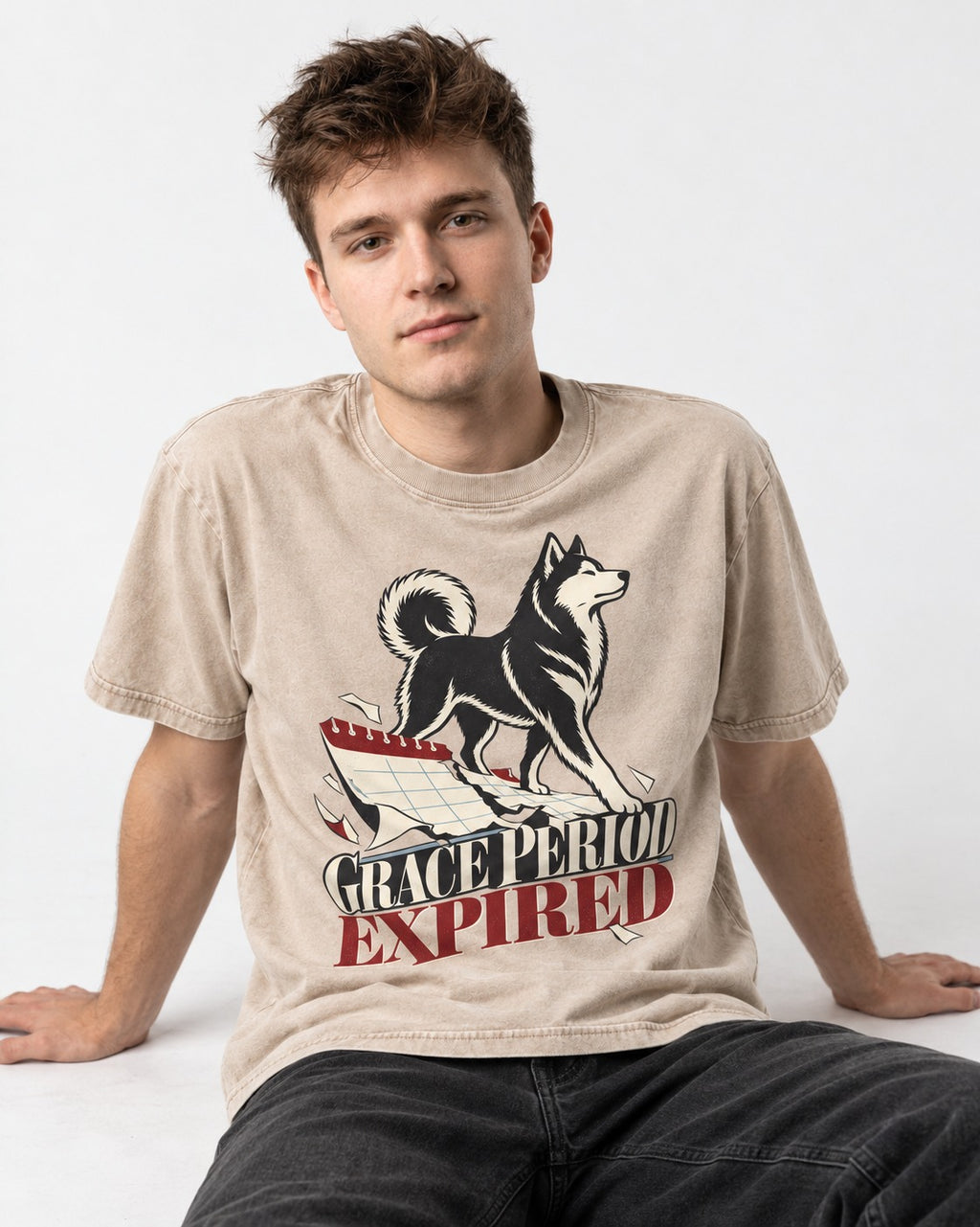 Husky Grace Period Expired Torn Calendar Graphic Washed Tee in Apricot, worn by a seated model