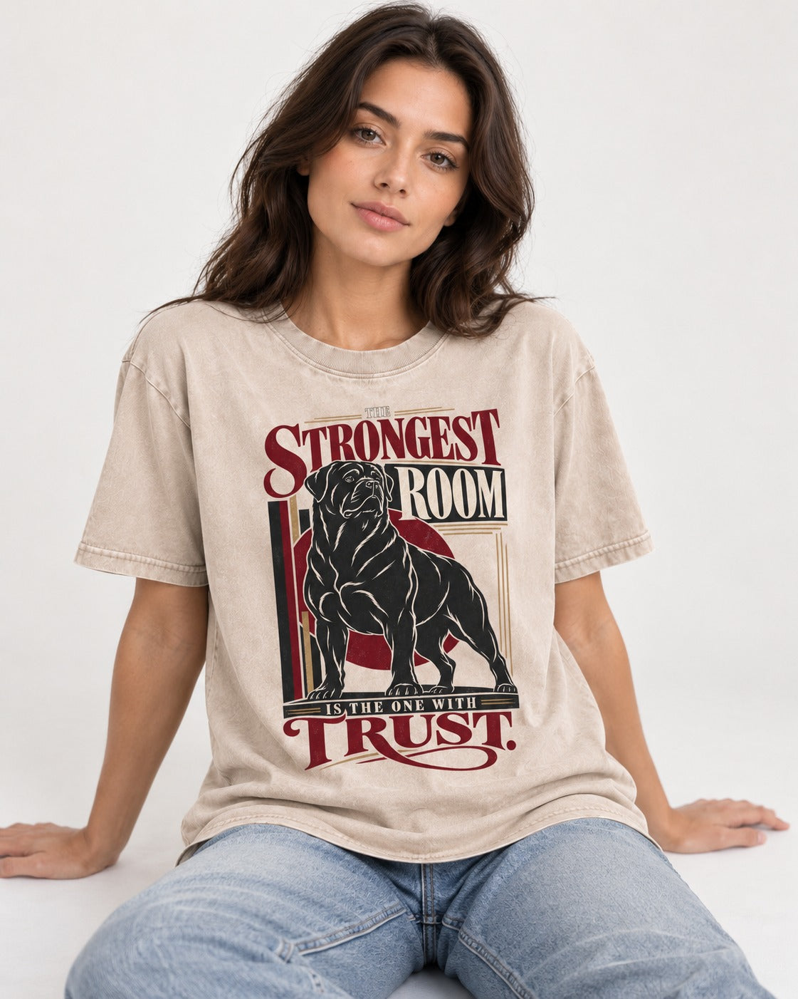 Rottweiler Trust Washed Tee in Apricot, worn by a seated model