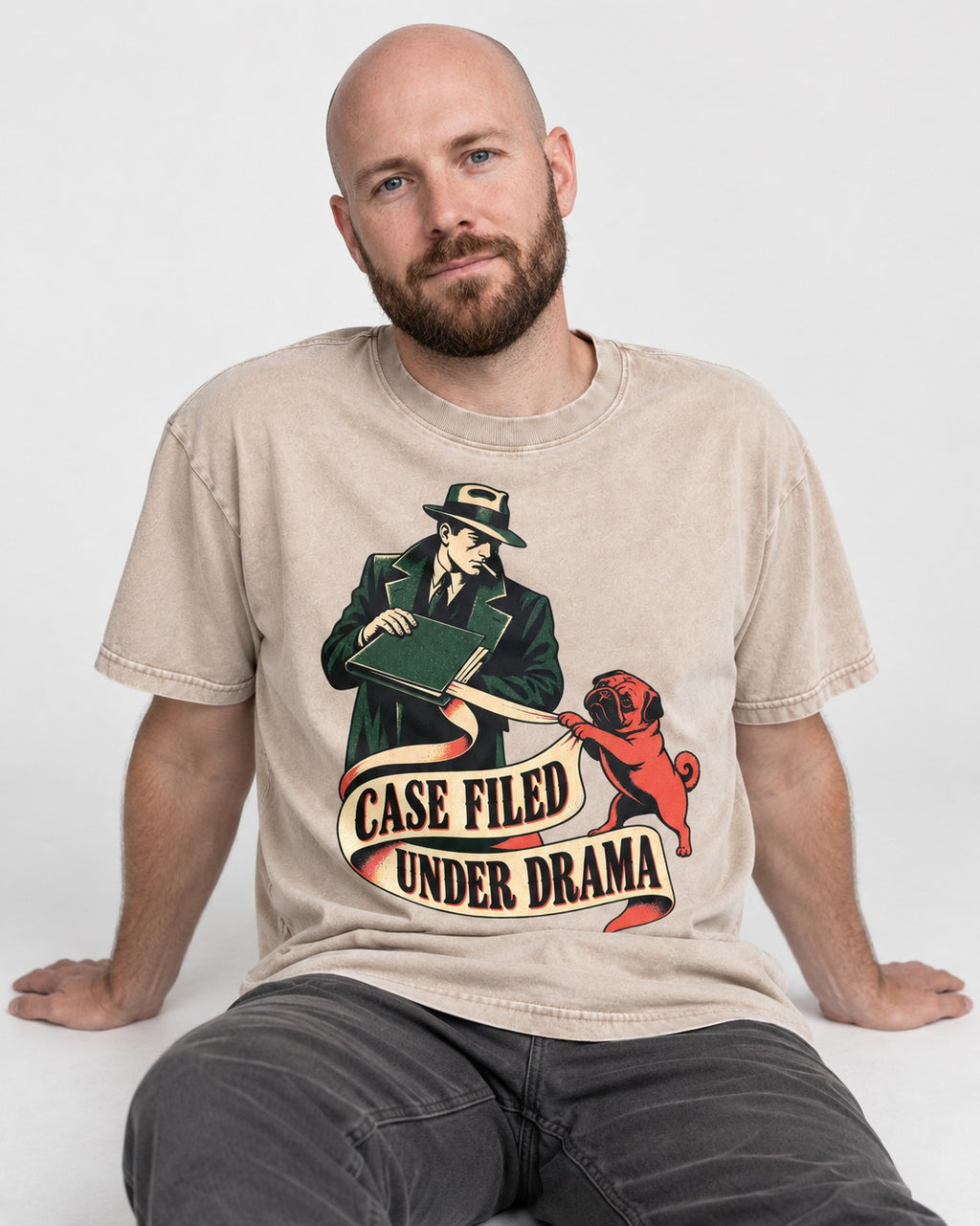 Pug Case Filed Under Drama Washed Tee in Apricot, worn by a seated model