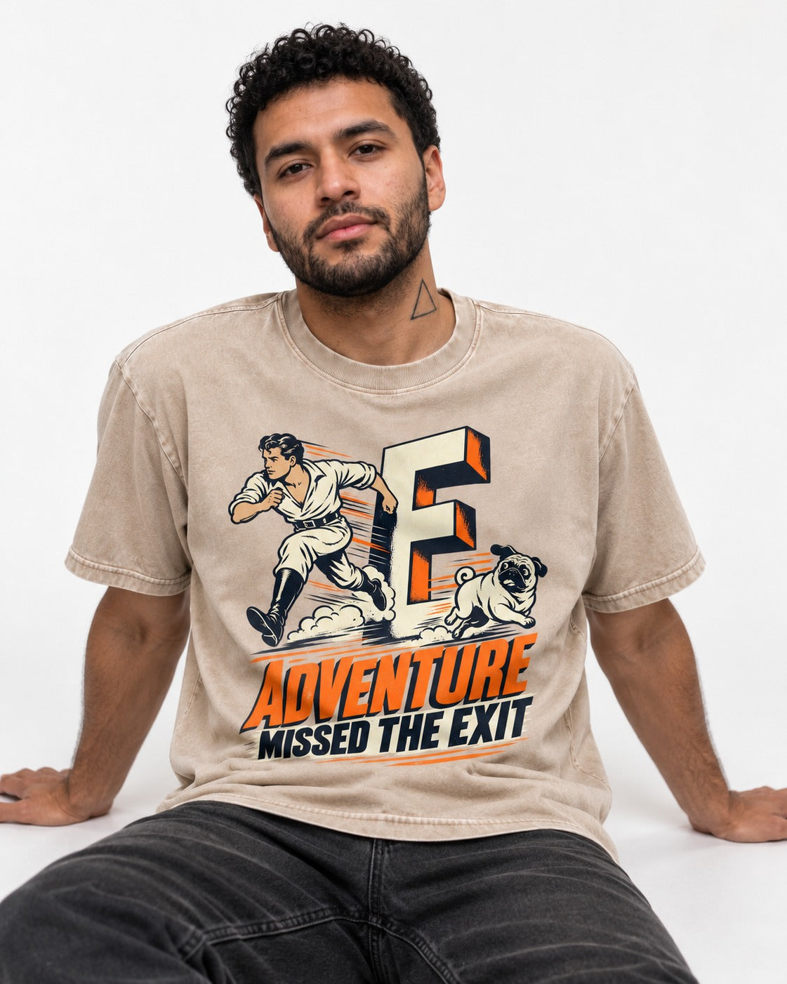 Pug Adventure Missed the Exit Running Graphic Washed Tee in Apricot, worn by a seated model
