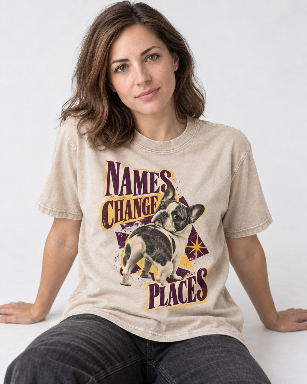 Frenchie Names Change Places Purple Poster Graphic Washed Tee in Apricot, worn by a seated model