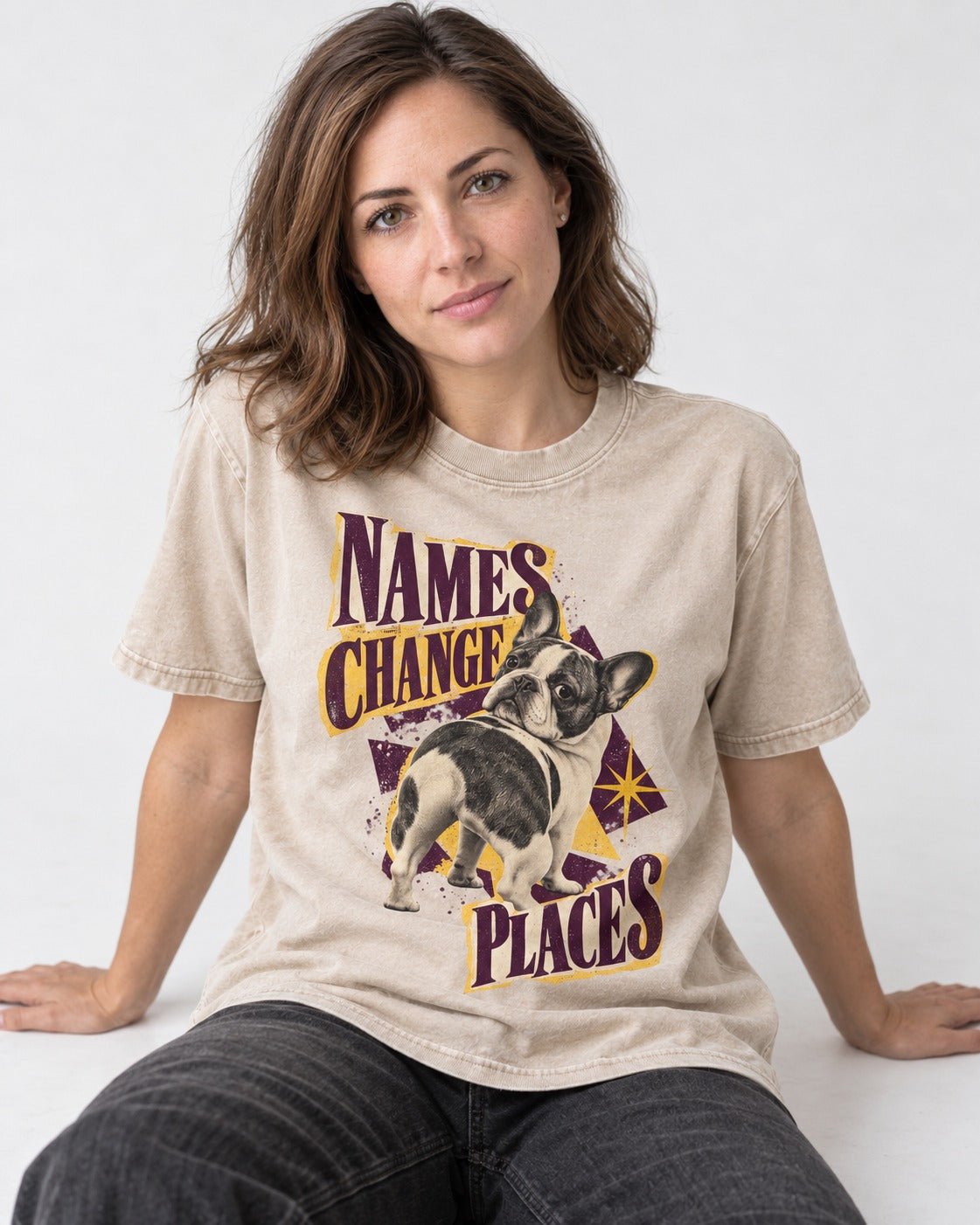 Frenchie Names Change Places Purple Poster Graphic Washed Tee in Apricot, worn by a seated model