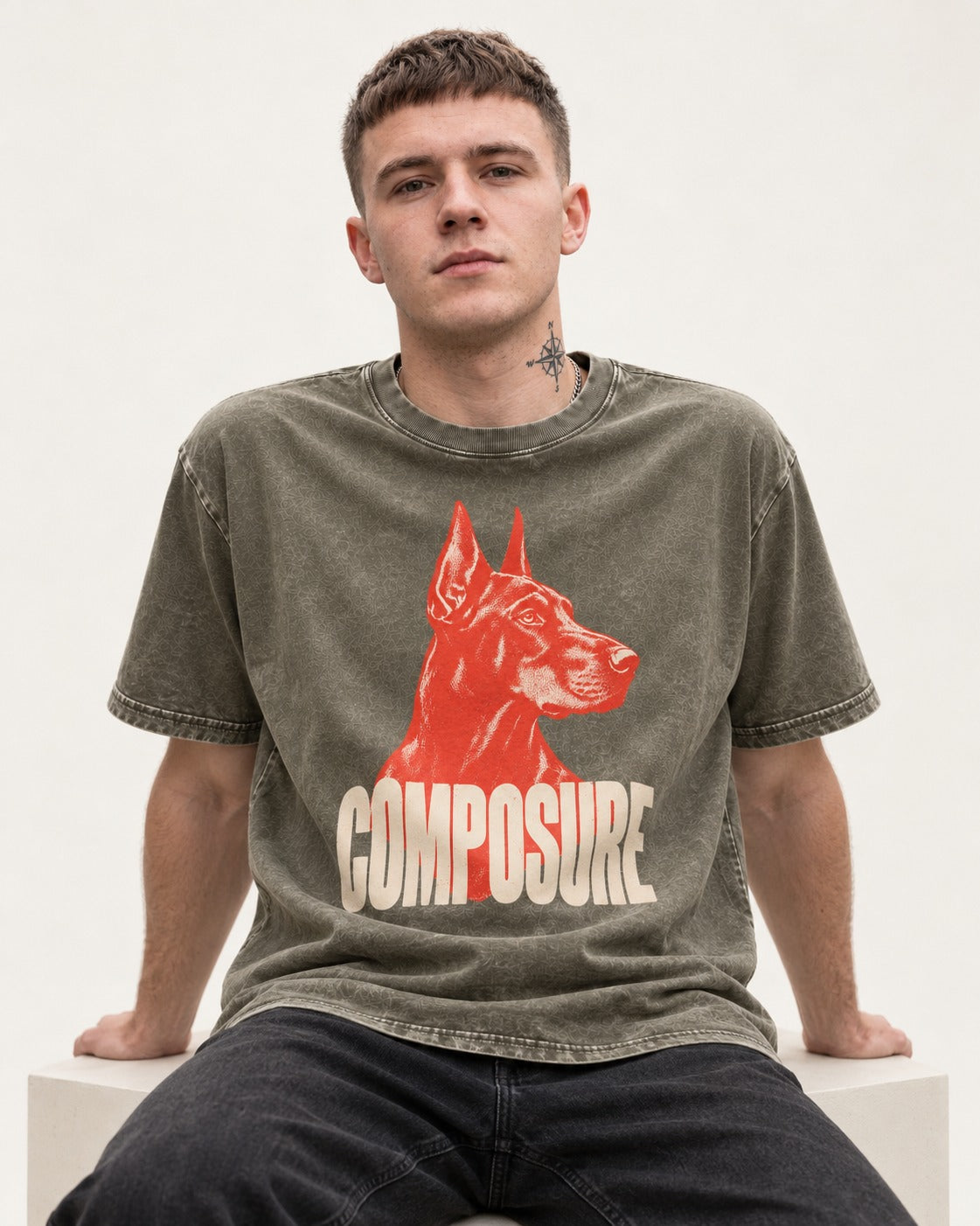 Doberman Composure Portrait Graphic Washed Tee in Army Green, worn by a seated model